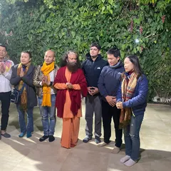 Our group of yoga practitioners from Vietnam standing with a revered spiritual leader in Rishikesh. We pride ourselves on creating authentic spiritual experiences for our international guests.