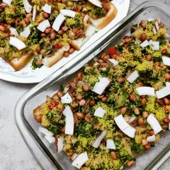A creative twist on a classic, this is our bread chaat. Toasted bread slices are topped with a mix of potatoes, onions, peanuts, sev, and fresh coconut, creating a crunchy and flavourful snack.