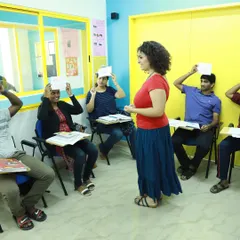 Learning is a game. Here, our students are playing a fun guessing game that helps them practice vocabulary and sentence structure in a relaxed, interactive setting.