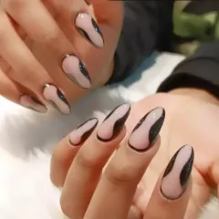 A trendy "lava lamp" design with glossy black abstract shapes over a sheer nude base on long almond nails.
