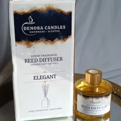 Each reed diffuser, like this 'Elegant' scent, comes in a beautifully designed box, making it ready for gifting. The bottle itself features a gold cap and a clean label.
