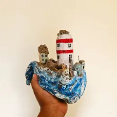 Another angle of the driftwood sculpture, showing the little houses from a different perspective. Each miniature building is crafted and painted by hand with incredible attention to detail.