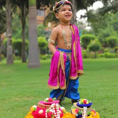 Our little natkhat cutie dressed as Krishna for Janmashtami. This custom-made dhoti and shawl set in vibrant blue and pink silk is perfect for celebrating the festival with playful innocence.