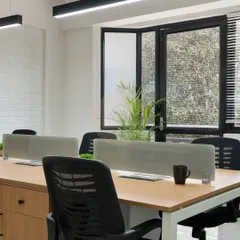 A look at the open workstation area at the Onestep Global office. We focused on a seamless workflow with clean lines, ergonomic chairs, and modern linear lighting. The white brick texture wall adds a touch of industrial chic.