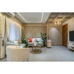 A wide shot capturing the flow from the living area to the TV unit and entryway. The consistent use of soft grey tones and elegant mouldings creates a cohesive and expansive feel throughout the space.