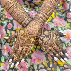 A beautiful bridal design featuring a mix of modern geometric patterns and traditional motifs like elephants and lotuses. The contrast between the filled and open spaces is striking.