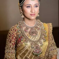 My course emphasizes creating a cohesive look. Notice how the makeup tones, with a subtle shimmer on the eyes and a defined lip, perfectly complement the warm gold of the saree and the antique finish of the jewelry.