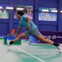 A senior player lunges for a difficult shot during a national ranking tournament. Our events feature high-quality courts that allow for dynamic, athletic play at the highest levels of competition.