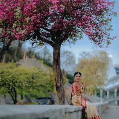 A beautiful wide-angle bridal portrait, using a blooming tree as a natural frame. This shows how we incorporate the environment to create stunning visuals.