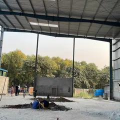 This is the interior of a pre-engineered building (PEB) structure during the construction phase. We specialize in planning and erecting these large-span steel structures for factories, workshops, and warehouses, ensuring a robust and efficient framework for any industrial operation.