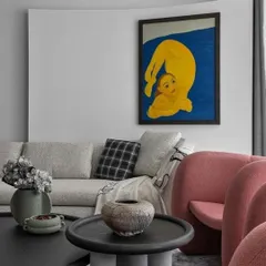 A close-up of the living room, featured in Elle Decor. The curved white wall was designed specifically to serve as a backdrop for the homeowner's art, turning the wall itself into a sculptural element that enhances the painting.