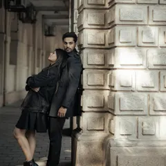 Using the strong lines and textures of Mumbai's architecture to frame the couple. This pose has a quiet, editorial feel, showcasing their connection amidst the grandeur of the city.