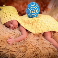 For our newborn sessions, we get creative with adorable, handmade costumes like this tiny snail outfit. Your baby will be sleeping peacefully on a soft, furry blanket while I capture their sweet, dreamy expressions in a whimsical nature-inspired setting.