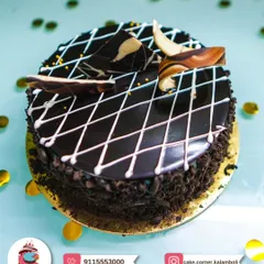 A delicious chocolate cake with a diamond pattern glaze and chocolate shards on top. A simple yet elegant choice for any occasion.