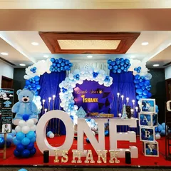 A "Little Star" first birthday for Ishank. This classic blue and white theme features a large teddy bear, "ONE" marquee letters, and a star-studded backdrop.
