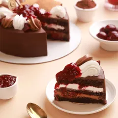 A look inside our classic Black Forest Cake. We use rich chocolate ganache, velvety vanilla bean cream, and a compote made from real, seasonal cherries to create this timeless, indulgent treat.