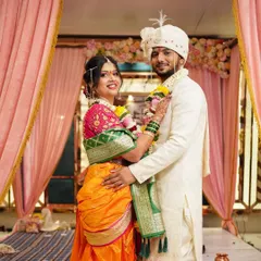 A classic portrait of the wedding couple. Her radiant makeup complements his traditional attire beautifully.