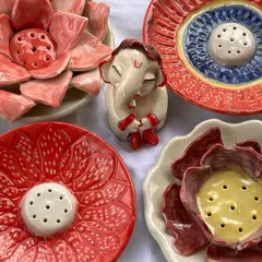 My colorful, flower-shaped incense holders are perfect for adding a touch of beauty to your prayer space. The little Ganesha in the middle brings a smile to my face.