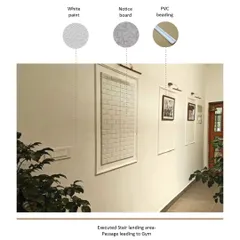 The passage leading to the gym features clean white walls with simple PVC beading to create a paneled effect. This detail adds a touch of classic elegance while keeping the space bright and functional with integrated notice boards.
