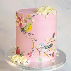 This tall, elegant cake showcases my love for hand-painted details. I used buttercream to paint delicate birds on branches, creating a unique and artistic centerpiece for a special 60th birthday celebration.