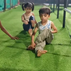 Working on flexibility is just as important as building strength. These young athletes are practicing their stretches on the turf, improving their range of motion.