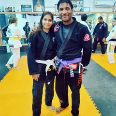 Posing with another skilled martial artist on the mats. Training in Jiu-Jitsu brings together people from all walks of life, united by their dedication to the art.