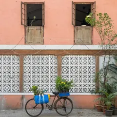 The exterior of my studio tells a story of revival. The salmon-pink facade, traditional jaali work, and classic wooden windows were carefully restored to honor the building's original character. It stands as a quiet reminder that with patience and love, forgotten spaces can find their purpose again.