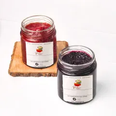 Two jars of handmade strawberry and blueberry jam, styled together for a clean e-commerce or product catalog shot.