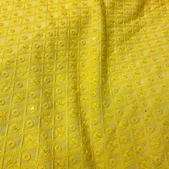 A vibrant yellow Chikankari fabric, ideal for a Haldi ceremony kurta or a bright festive outfit. The detailed threadwork creates a rich texture.