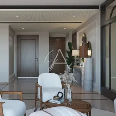 This drawing room is defined by neutral tones and minimalist patterns. The armchair and console table create a welcoming entryway, leading into the main seating area.