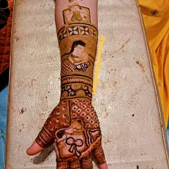One hand from the baby shower set, showing the father and baby portrait, a baby in a cradle, and a mundan ceremony scene.
