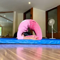 The extraordinary are here to create their own worlds. This student works on her chin stand, an advanced back-bending pose that requires significant flexibility and strength.