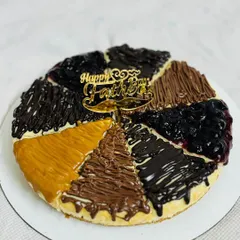 Perfect for sharing, this is my assorted baked cheesecake, made specially for Father's Day. It features slices with different toppings like blueberry, chocolate, Nutella, and Biscoff, so there's a flavor for everyone.