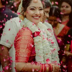 The pure joy of a South Indian bride, showered with petals after her wedding ceremony. Her radiant smile and the vibrant traditions make for beautiful, timeless photographs.