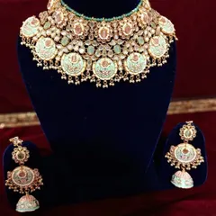 This is one of my colorful meenakari sets. The combination of mint green enamel work and Kundan stones makes it a unique and eye-catching choice.