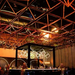 A wider view of the venue, showing how the bar installation complements the industrial architecture of the Taj The Trees.