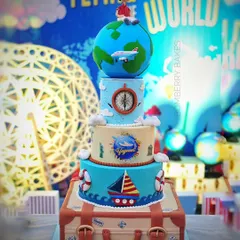 For a 5th birthday, I created this massive four-tier "Around the World" themed cake. The design features a rotating globe on top and a detailed suitcase base, showcasing my ability to handle large, intricate projects.