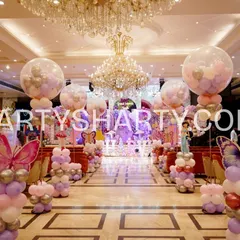 We create stunning, immersive entryways that set the theme from the moment guests arrive. This long aisle for a butterfly princess party is lined with custom balloon sculptures and character props, building anticipation for the main event.