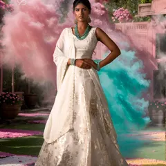 Embracing the vibrant spirit of Holi in pure elegance. This stunning white lehenga with gold foil print is a perfect example of festive wear that is both joyful and sophisticated.