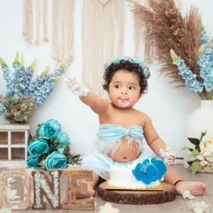 A fun and messy cake smash in our blue boho-themed setup. We love capturing the moment they first dive into the cake.