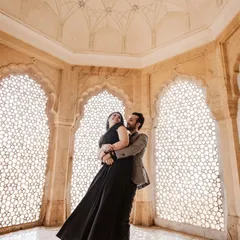 Inside the intricate marble halls of Amer Fort, we captured this moment of pure joy. The way the light filters through the jali windows creates a timeless, fine-art feel, perfect for a couple wanting elegant and romantic portraits.