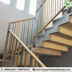 This custom metal staircase railing was fabricated for a farmhouse, designed to be durable and functional. The two-tone finish on the vertical bars adds a subtle design element to the otherwise practical structure.