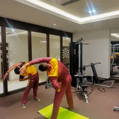 Pre-game warmups are essential for athletic performance. Here, I'm leading a side-body stretch to improve mobility and prepare the muscles for the demands of a professional cricket match.