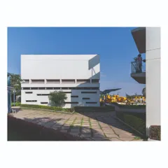 A view across a paved courtyard between two buildings at the Ajax factory. The design creates a series of "pause points" and open spaces that break up the mass of the built forms and integrate the campus seamlessly.