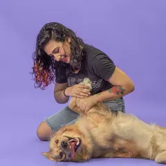 We believe the best shots come from genuine moments of play. During a campaign shoot, we captured this candid interaction, showing a happy Golden Retriever enjoying a belly rub against a clean, purple studio backdrop.