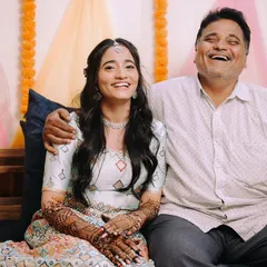 A father's joyful laugh is one of the most precious things to capture on a wedding day. This candid moment between the bride and her dad is priceless.