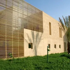 For the Indian Oil Tanking Ltd. office in Sohar, Oman, I used a simple palette of stucco and wooden screens to respond to the desert climate. The design balances the need for shade with the desire for natural light and views.