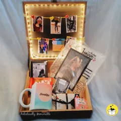 A beautifully curated hamper for her birthday, with the theme "You are my Person." The light-up box is filled with photos, a mug, chocolates, and other personal touches.