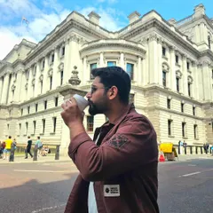 A candid-style photo of me enjoying a coffee on a London street. This natural, in-the-moment shot is effective for lifestyle brands that want to convey an authentic, everyday feel.