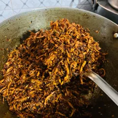 Here is my spicy chicken pickle being prepared in a large pan. I make sure to fry the shredded chicken until it's perfectly crisp before mixing in the masalas.